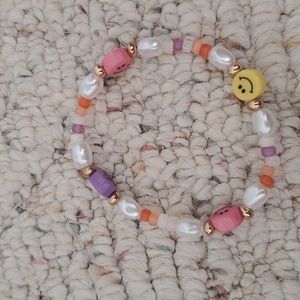 smiley pearl and charm bracelet